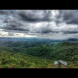 Scenic view of landscape against cloudy sky