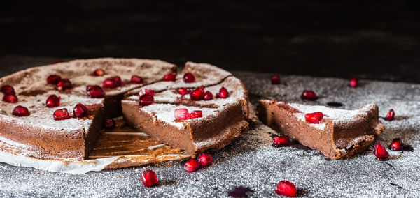 Close-up of pomegranate seeds on chocolate cake