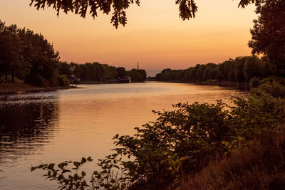 Scenic view of lake against orange sky