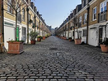 Empty alley amidst buildings in city