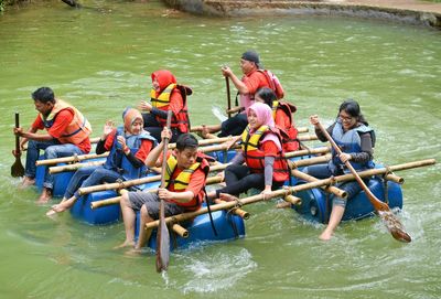 View of people in calm lake