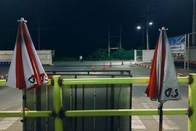 Flags on illuminated street lights at night