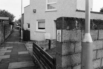 Empty alley amidst buildings in city