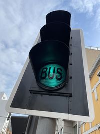 Low angle view of road sign against sky