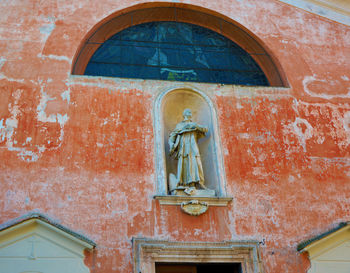 View of cross on brick wall