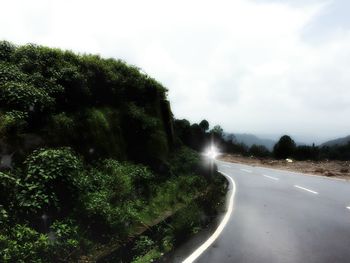 View of road against cloudy sky