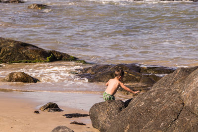 Woman on rock at beach