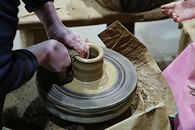 Sculptor making clay pot at workshop