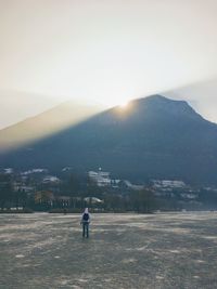 Rear view of man on landscape against sky