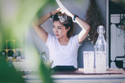 Woman hand in hair sitting at table