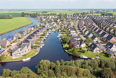 Aerial from a typical dutch village with litte canals in nes in friesland the netherlands