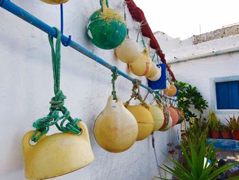 Buoys hanging from rod outside house