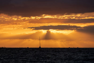 Scenic view of sea against orange sky