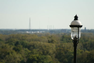 Street light on field against sky