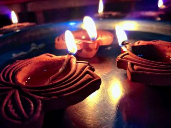 Close-up of lit candles on table