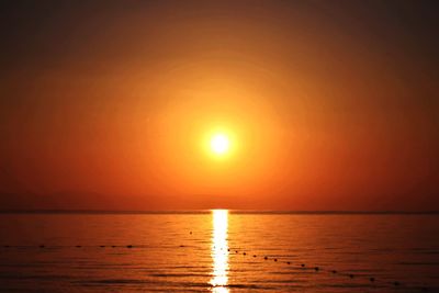 Scenic view of sea against orange sky