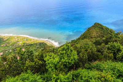 High angle view of sea and trees against sky