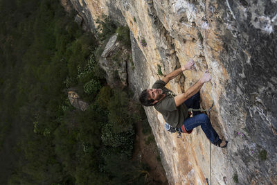 High angle view of man rock climbing