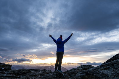 Figure at sunset overlooking the mountains, southern alps new zeala