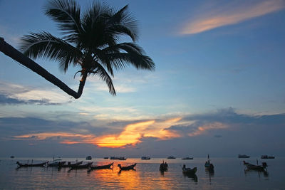 Silhouette boats in swimming pool against sky during sunset