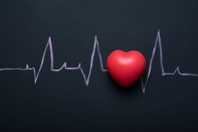 Close-up of red heart shape over black background