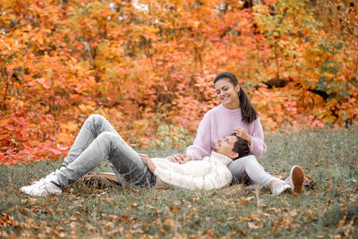 Happy couple at park during autumn