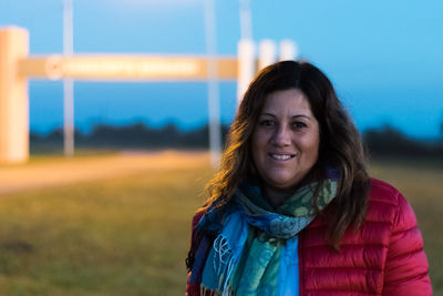 Portrait of smiling woman standing outdoors