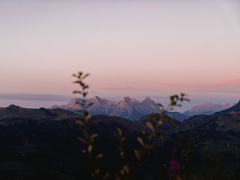 Scenic view of snowcapped mountains against sky during sunset