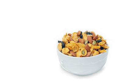 Close-up of fresh fruits in bowl against white background