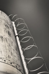 Low angle view of ladder on silo against sky