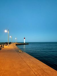 Scenic view of sea against clear blue sky