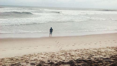 Full length of man standing on beach