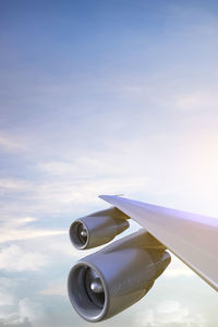 Low angle view of airplane flying against sky