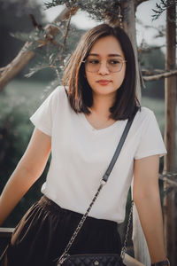 Portrait of young woman standing outdoors