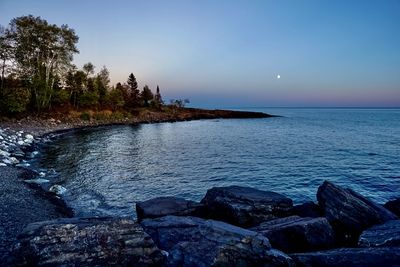 Scenic view of sea against sky at dusk