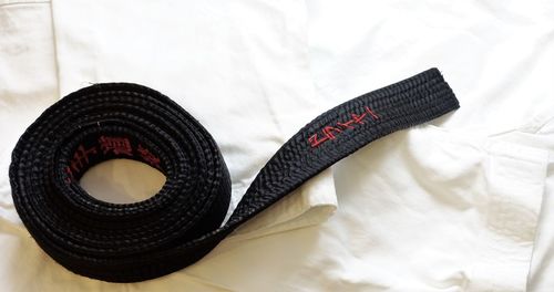 Close-up of karate black belt on cloth