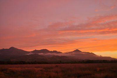 Scenic view of silhouette mountains against sky during sunset