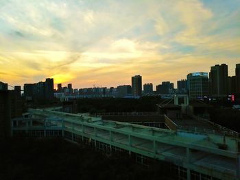 Cityscape against cloudy sky