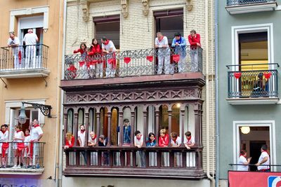 People standing by railing in city