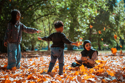 Side view of young woman standing on field