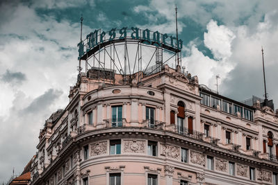 Low angle view of building against cloudy sky