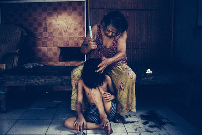Young woman sitting on wall