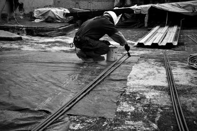 High angle view of people working at railroad tracks