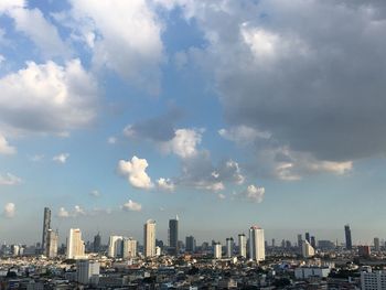 Cityscape against cloudy sky