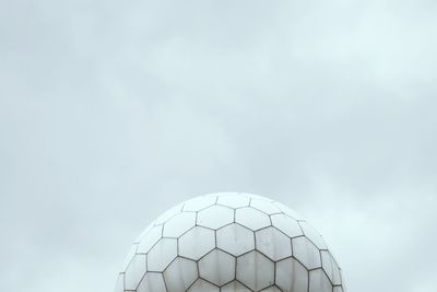 Low angle view of radar at national security agency against sky