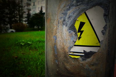 Close-up of arrow sign on grass