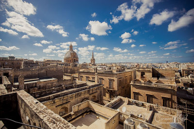 Buildings against cloudy sky