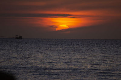 Scenic view of sea against romantic sky at sunset