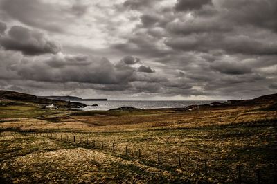 Scenic view of landscape against cloudy sky