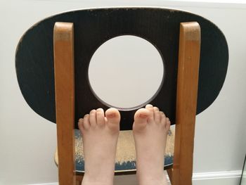 Low section of human feet on wood